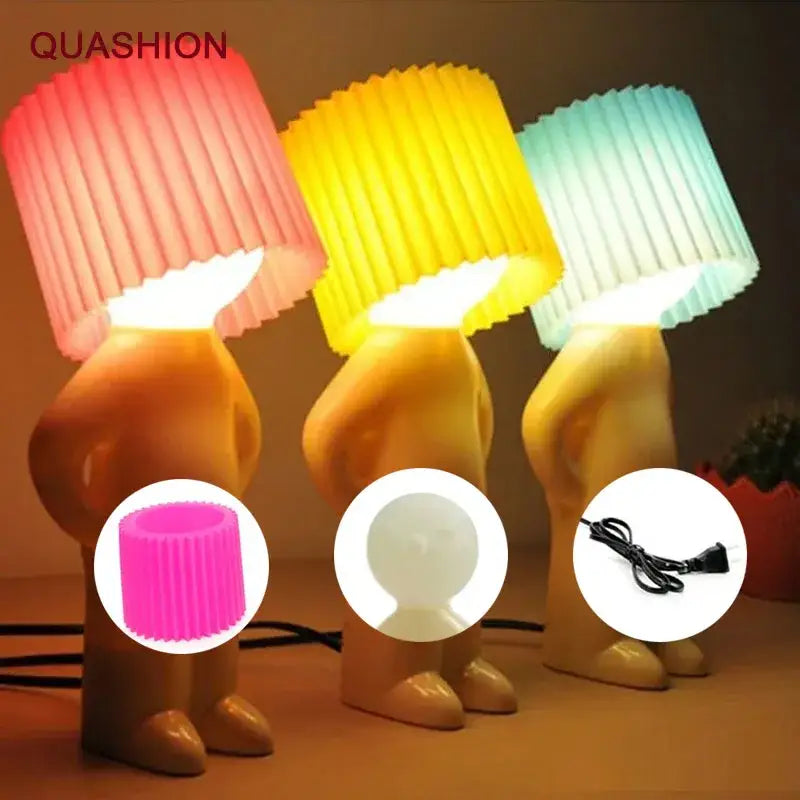 Three whimsical night light lamps with golden humanoid bases and pink yellow teal pleated shades for decorbites creative night light