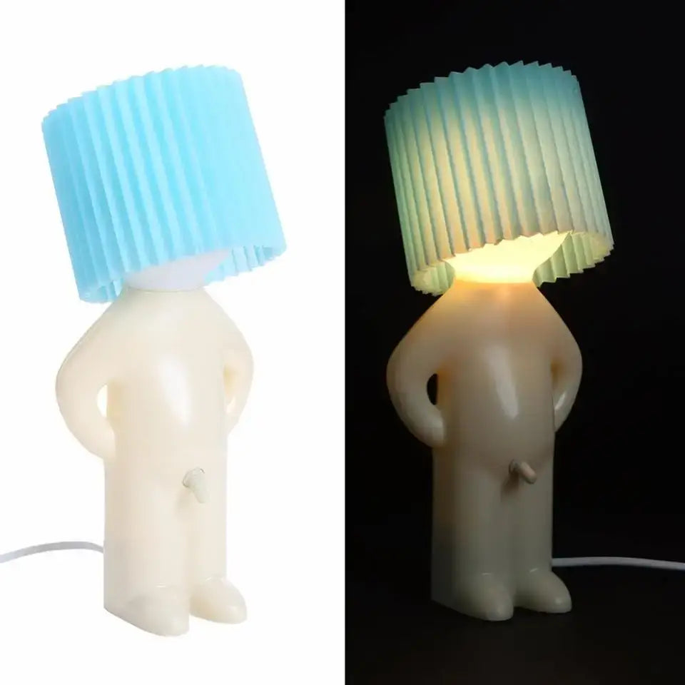 Whimsical white figurine lamp with pleated blue shade glows warmly as a creative night light decorbites night light