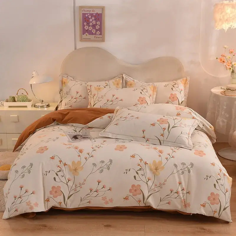 A soft cream bedding set with peach and yellow blossoms featuring decorbites cotton thickened fabric and a brown throw