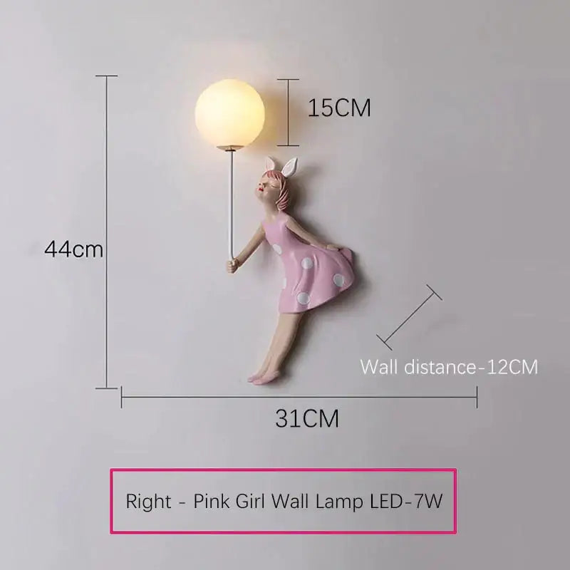 Whimsical pink girl wall lamp featuring a LED light with a polka dot dress figurine holding a spherical bulb for bedroom