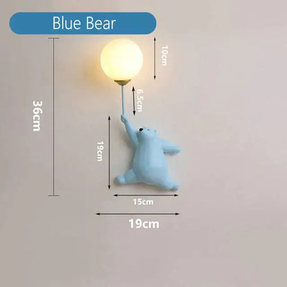 Light blue resin polar bear wall lamp holding a spherical bulb complements whimsical pink polka dot girl wall lamp