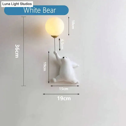 White polar bear girl wall lamp with spherical frosted glass bulb featured in whimsical pink polka dot bedroom design