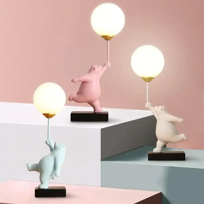 Three whimsical polar bear moon table lamps with glowing spherical lamps and gold-tone bases for bedroom decor