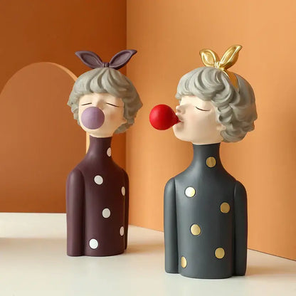 Two whimsical bubble girl resin figurines in polka dot dresses with balloons perfect for living room decor