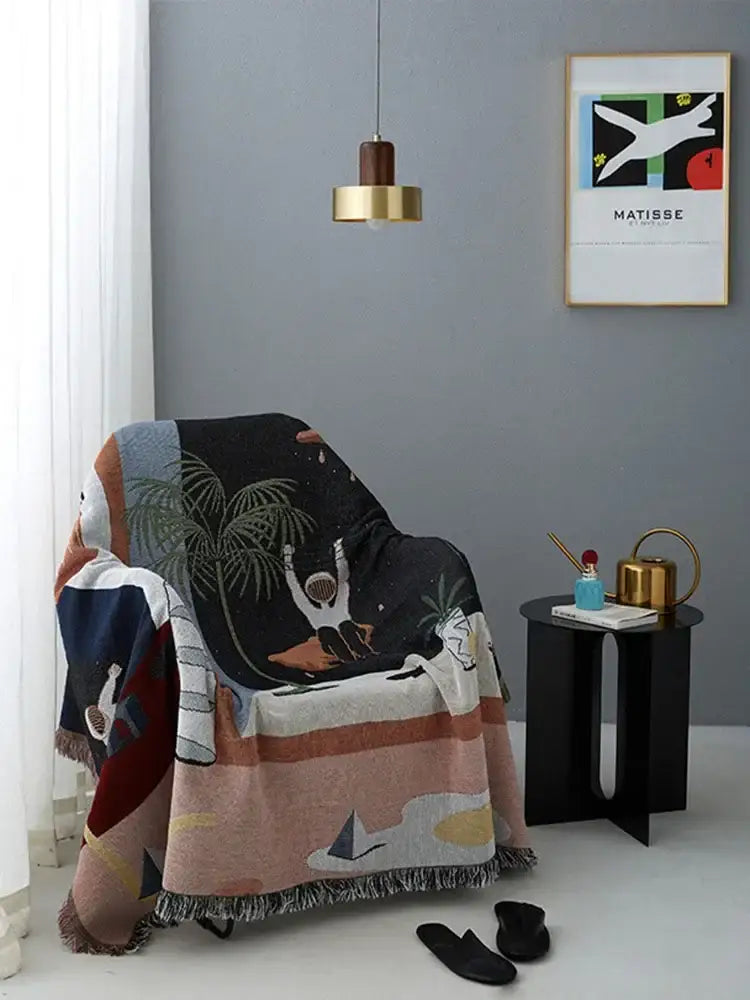 A cozy multicolored whimsical tropical knit sofa blanket draped over an armchair by decorbites knit sofa decorbites knit