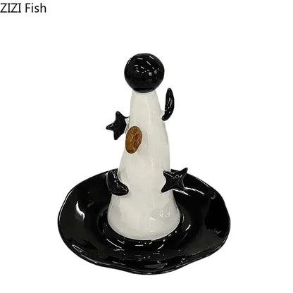 Whimsical black and white ceramic penguin jewelry display stand with glossy finish and gold chest detail for bedroom decor