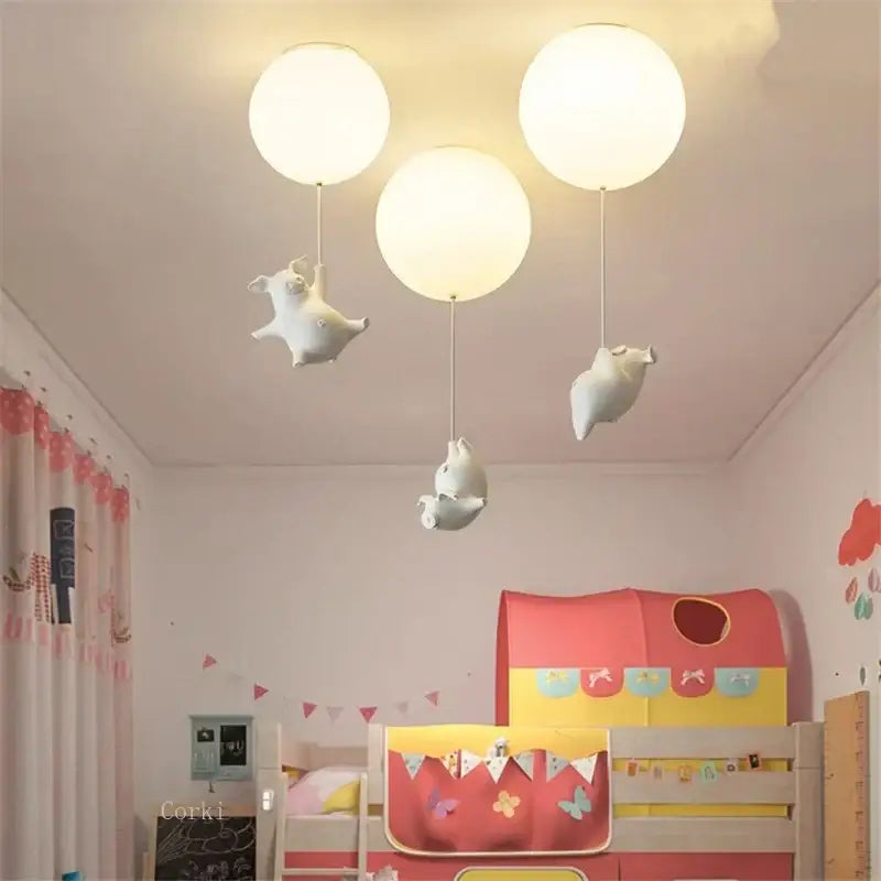Whimsical white balloon ceiling light featuring three flying pig resin led figurines for bedroom decor