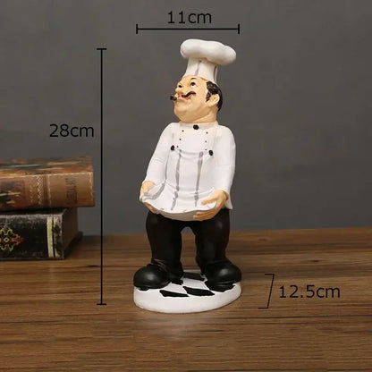 Whimsical white and black bearded chef resin figure with tall toque standing on circular base kitchen decor