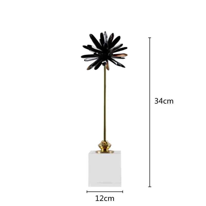 Black glossy petal-like home decor figurine on a gold stem with clear acrylic base for elegant living room decor