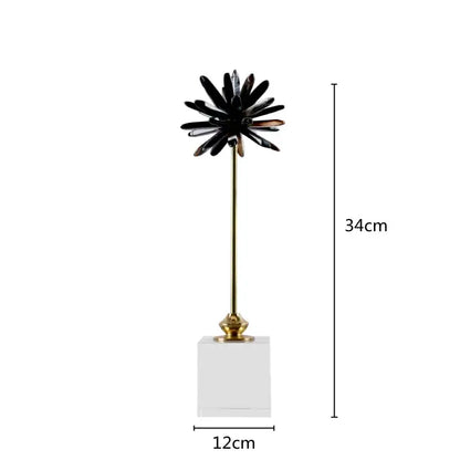 Black glossy petal-like home decor figurine on a gold stem with clear acrylic base for elegant living room decor