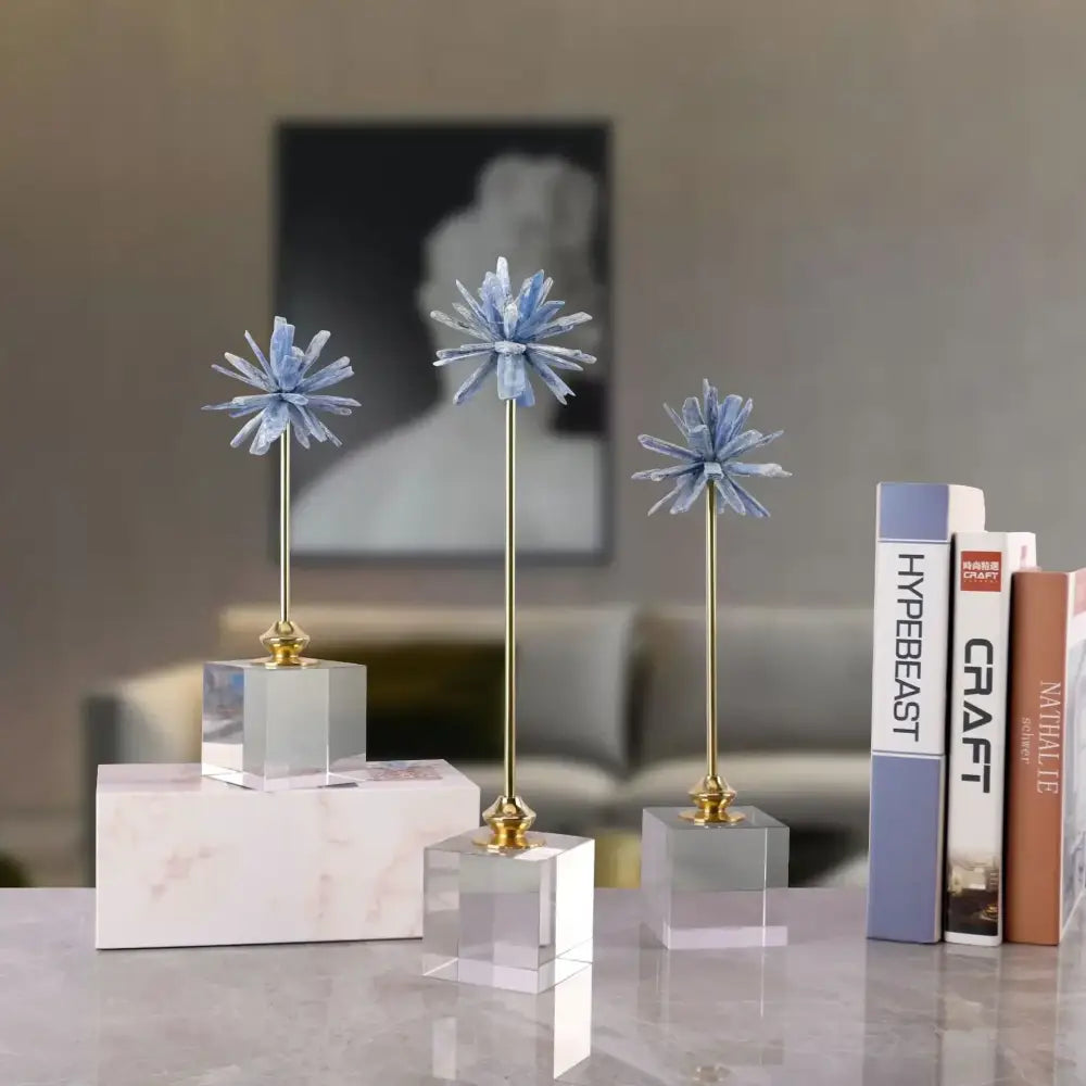 Three elegant blue crystal flower home decor figurines with gold stems and clear acrylic bases for living room display