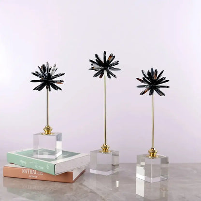 Three black starburst home decor figurines with gold stems on clear acrylic bases for living room decor