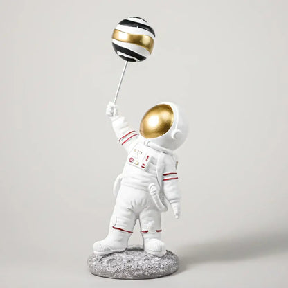 White astronaut figurine with gold helmet and red trim holding black and gold striped balloon for living room decorbites astronauts figurines