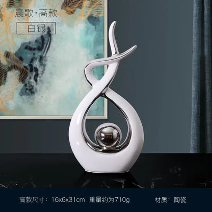 White and gold ceramic abstract figurine set featuring sleek white ceramic curves and a polished silver sphere for decorbites decor