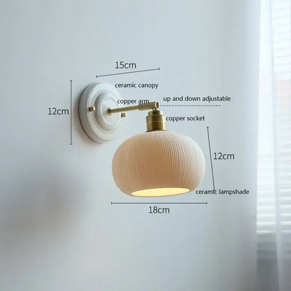 Cream-colored ceramic led wall light with ribbed lampshade and brass-finished copper arm for bedroom decorbites ceramic led wall