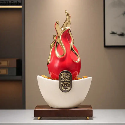 A glossy red and gold flame-shaped feng shui ornament with chinese characters on a white ceramic base and wood stand