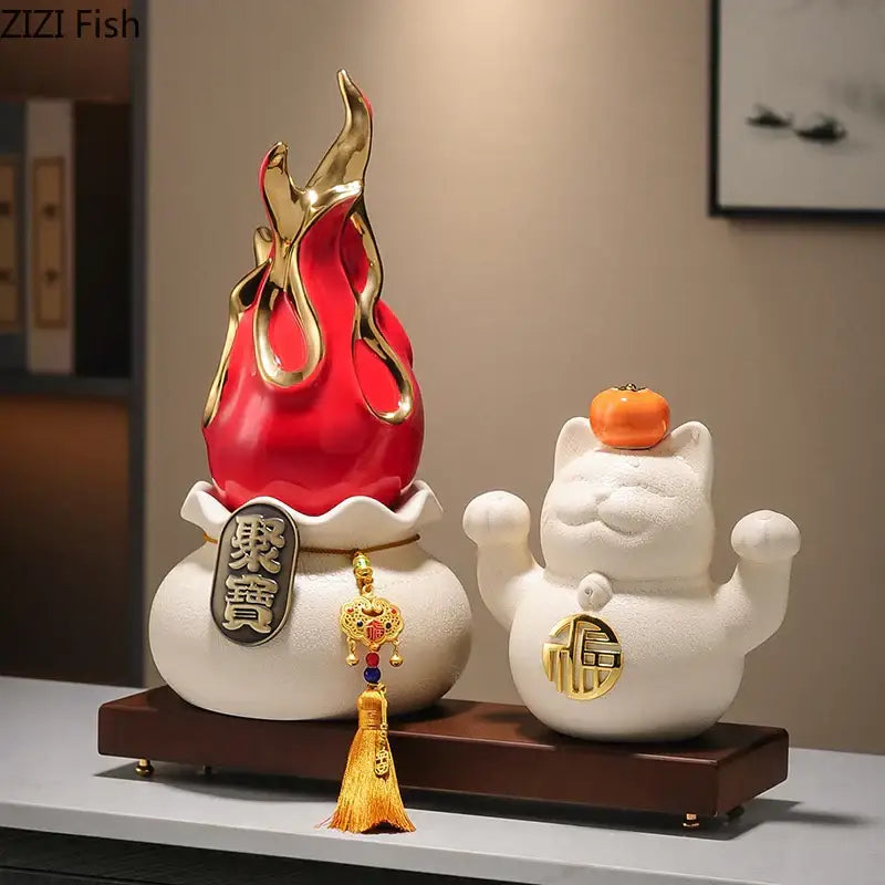 White and gold ceramic lucky cat feng shui ornament with small orange pumpkin for living room decor
