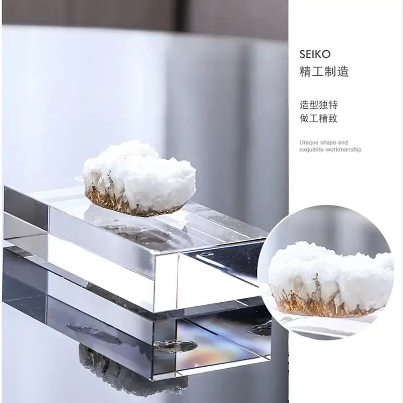 A white and gold crystal coralline ornament with golden mineral inclusions on a transparent acrylic stand for decor