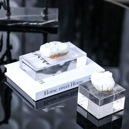 White and gold crystal coralline ornaments featuring white quartz crystal geodes on clear acrylic cube stands for living room decor
