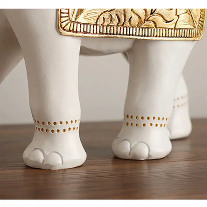 White and gold elephant sculpture figurine showing the back with gold-embossed decorative details for living room decor