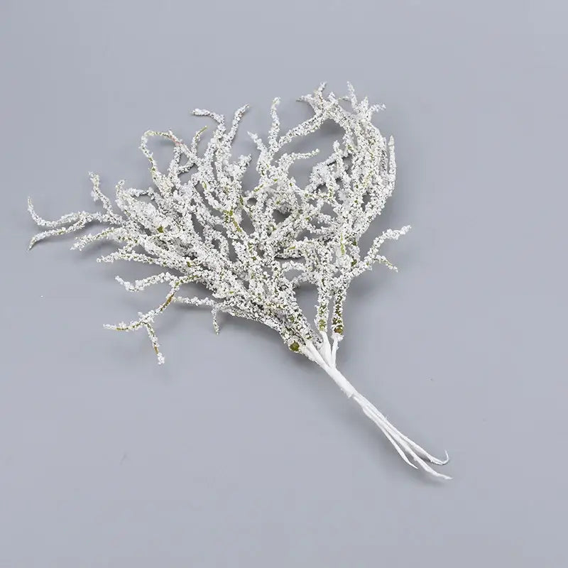 A delicate white frosted coral branch with green accents in white and gold glitter artificial branches home decor by decorbites