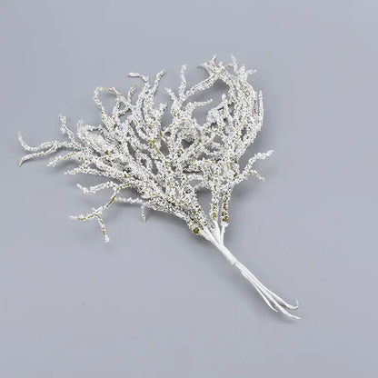 A delicate white frosted coral branch with green accents in white and gold glitter artificial branches home decor by decorbites