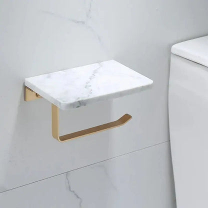 White and gold marble toilet paper holder with gold-tone metal base and curved support arm by decorbites gold marble