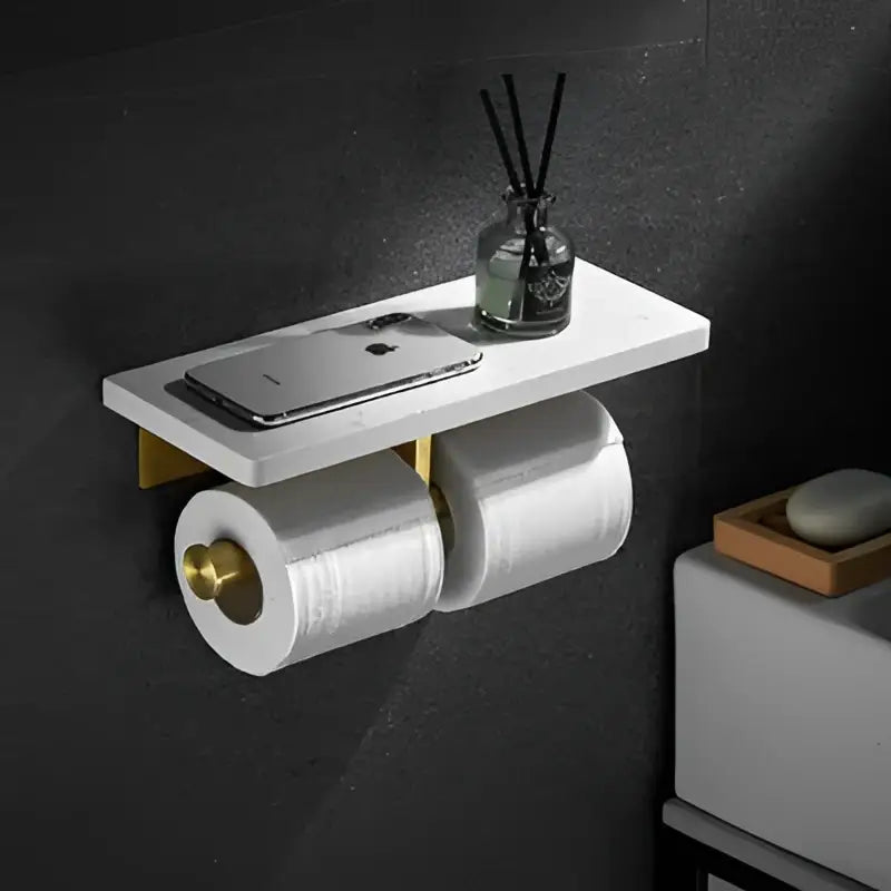 White marble-style wall-mounted paper holder with gold-tone brackets in decorbites gold marble bathroom shelf design