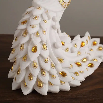 White and gold peacock sculpture with intricate feathers and golden teardrop embellishments for home decor by decorbites golden phoenix