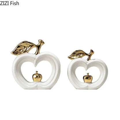 White and gold pear ceramic desk ornament featuring white apple sculptures with gold leaf and miniature golden apples inside heart cutouts