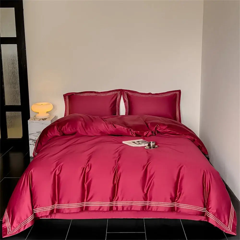 Rich burgundy satin bedding set with elegant white piping featured alongside white and gray egyptian cotton decorbites 1200tc embroidered duvet cover