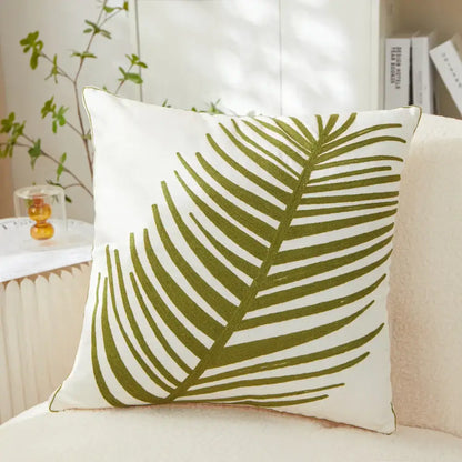 White pillow cover with olive green embroidered leaf design perfect for living room décor and comfort