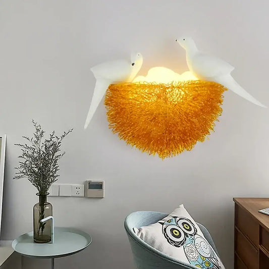 White ceramic doves perched above a vibrant orange textured nest led wall lamp for bedroom decoration