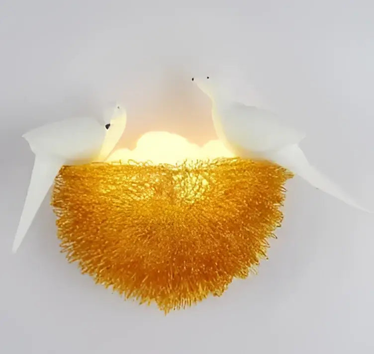 White and orange bird nest led wall lamp with glowing golden nest and two white bird sculptures for bedroom decor