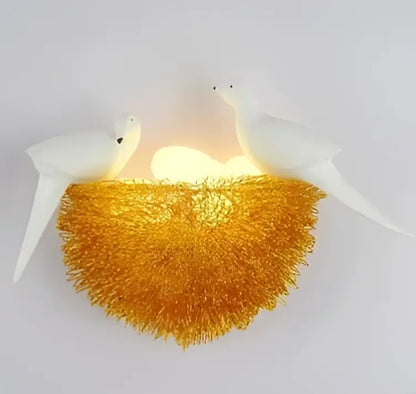White and orange bird nest led wall lamp featuring a glowing golden nest design with two white birds for bedroom decor