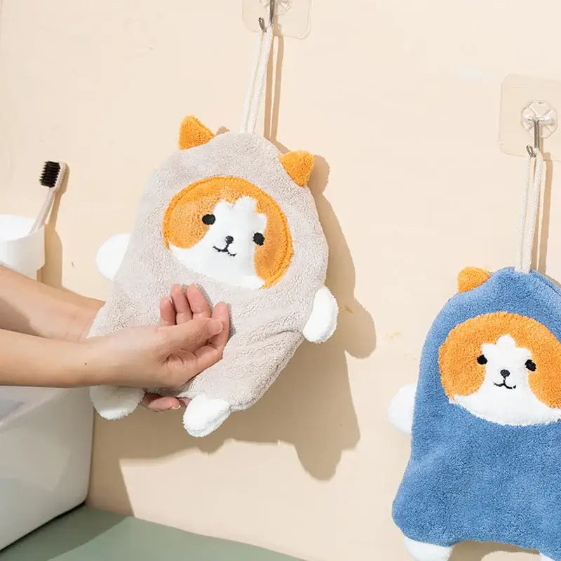 Soft gray coral plush cat hand towel with orange and white cat face decor hanging on wall hook for bathroom decorbites coral plush