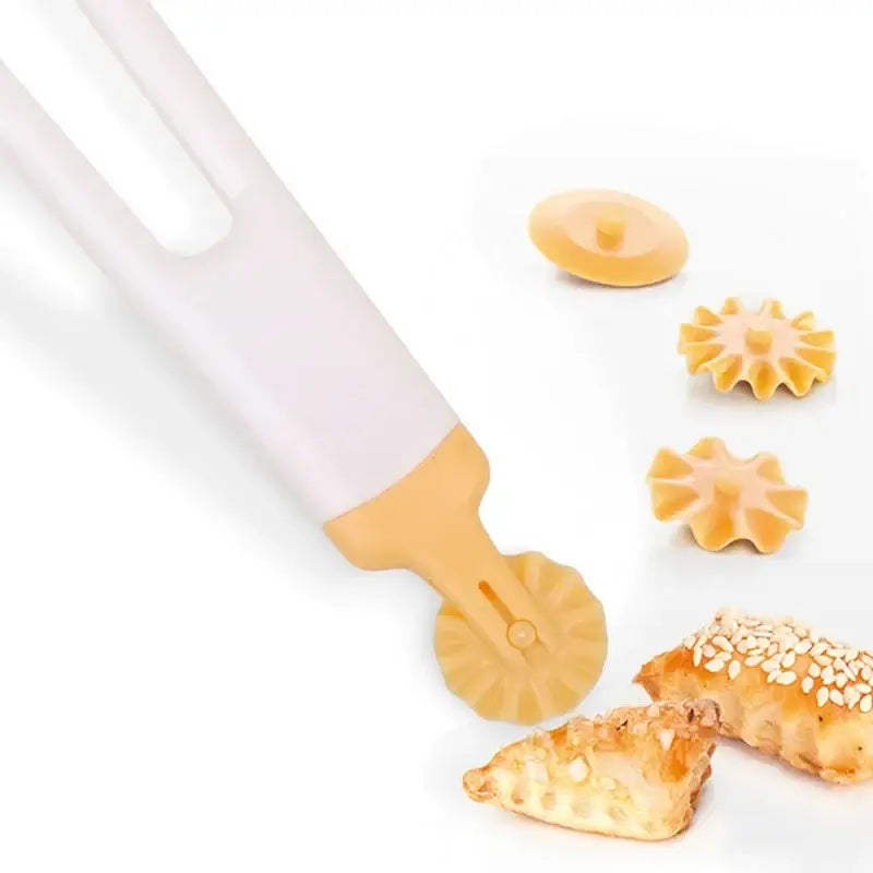 Beige and white decorbites dough roller cutter with interchangeable star-shaped attachments for decorative pastry use