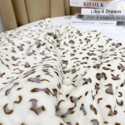A cream-colored plush fleece throw with brown leopard print featuring decorbites leopard print warm blanket design