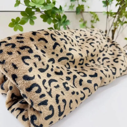 A plush white and orange leopard print warm fleece blanket with soft fuzzy texture for cozy bedroom decorbites leopard print