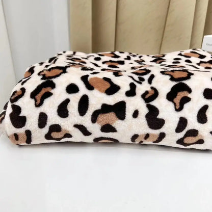 A plush cream-colored fleece throw with bold black and tan leopard print warm perfect for decorbites leopard print decor