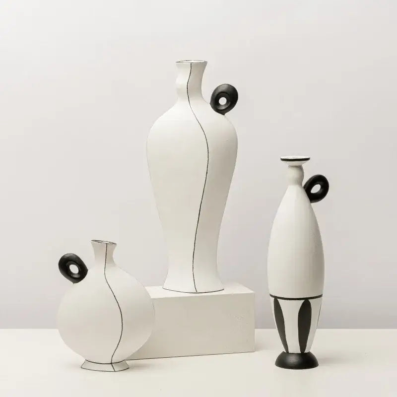 Set of three minimalist white ceramic vases with geometric black lines and black circular handles for living room decor