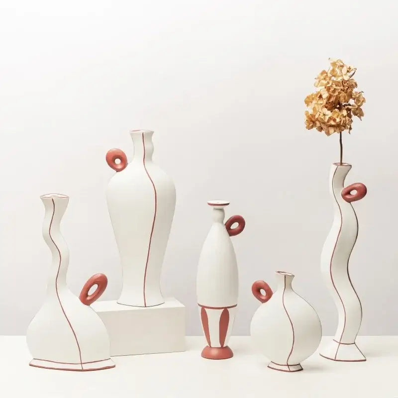 White ceramic vases with terracotta handles and geometric black lines for living room decor