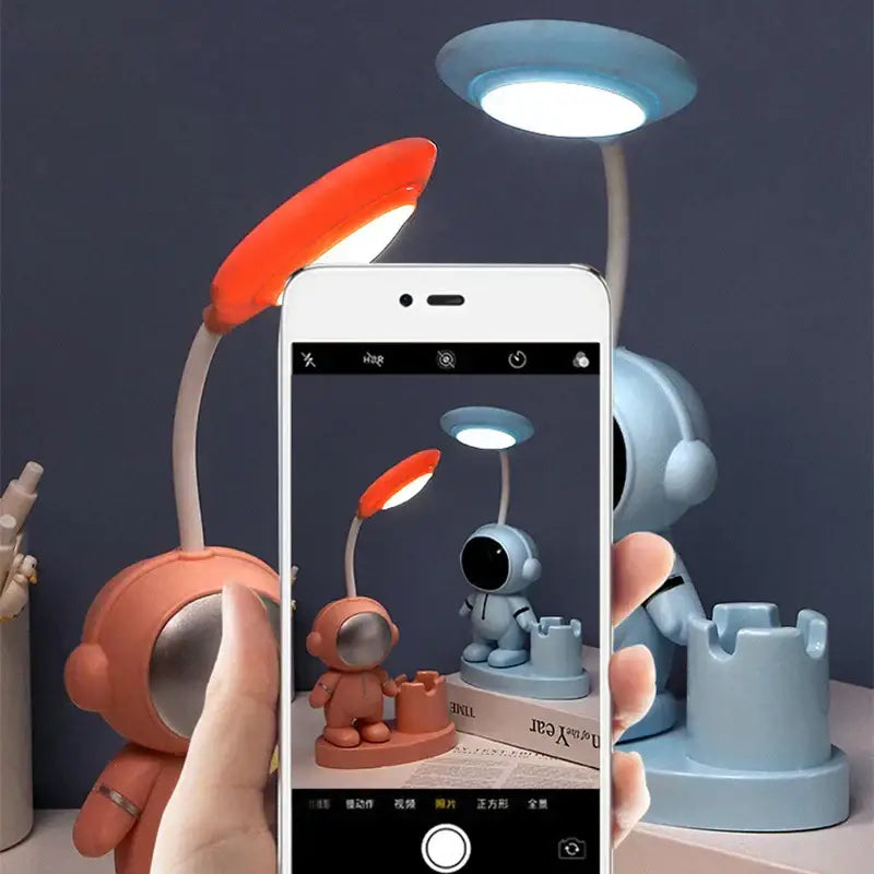 A charming coral desk lamp shaped like an astronaut with flexible neck bright led light and pencil sharpener decorbites astronaut study