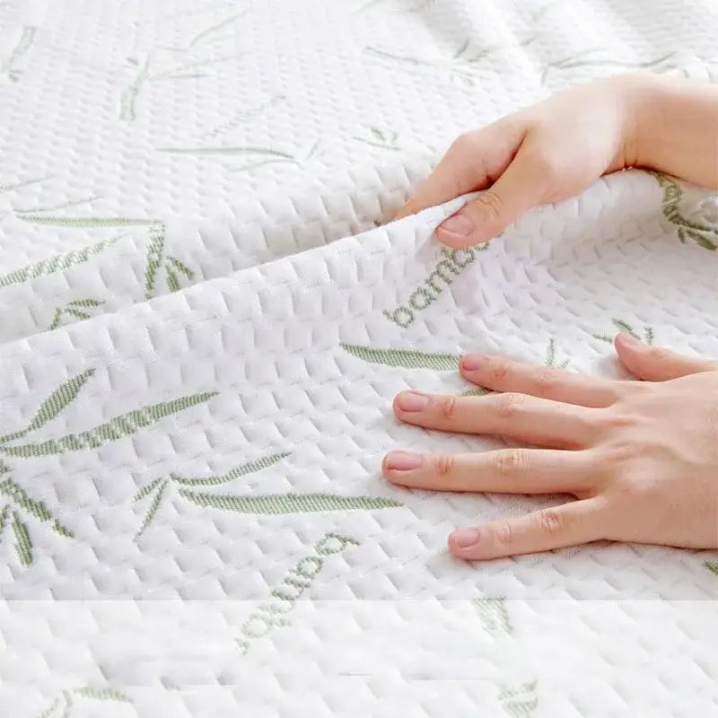 White bamboo jacquard waterproof fitted mattress cover with subtle green leaf and bamboo text embroidery for decorbites