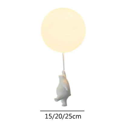 White ceramic cartoon bear ceiling light holding a glowing round balloon lamp for kids bedroom decorbites cartoon bear