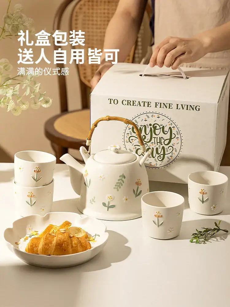 White ceramic daisy teapot set with delicate floral decals and natural bamboo handle for kitchen tea use