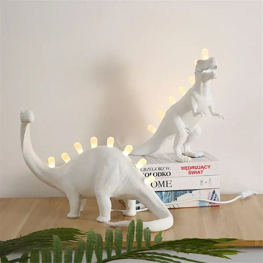 White ceramic dino led desk lamp with glowing led lights along its back and tail for bedroom decorbites dino led lighting