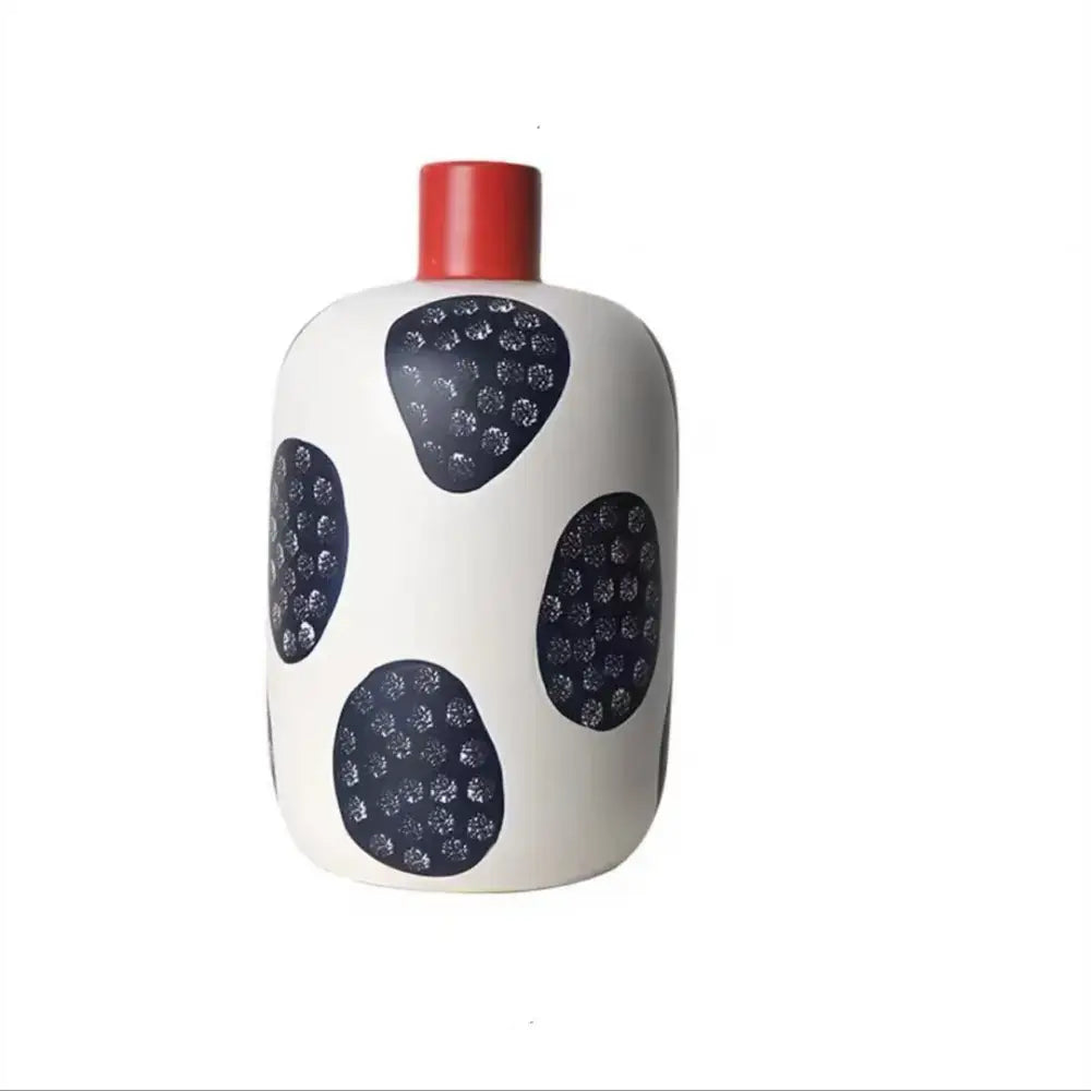 White ceramic vase with a red neck and black textured ovals featuring colorful graffiti lines for living room decor