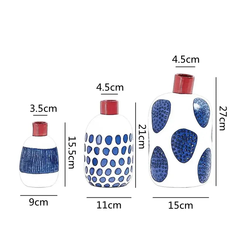 Three white ceramic vases with blue patterns and red caps featuring colorful graffiti lines for living room decor