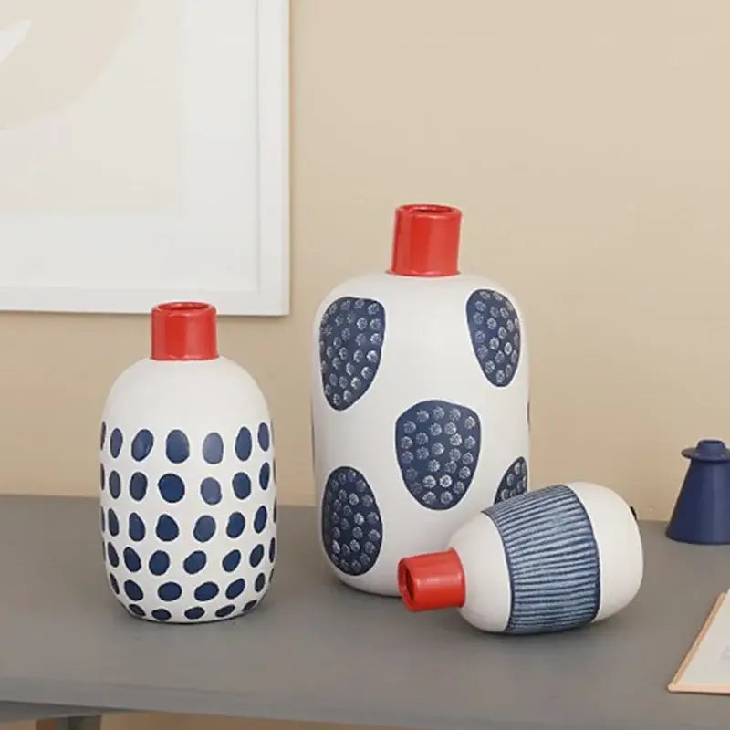 White ceramic polka dot vase with red caps featuring colorful graffiti lines for living room decor
